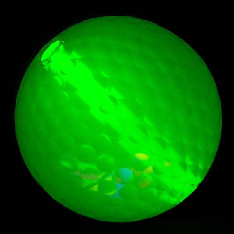 A green ball is shown in the dark.