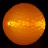 A close up of an orange ball with light shining on it.