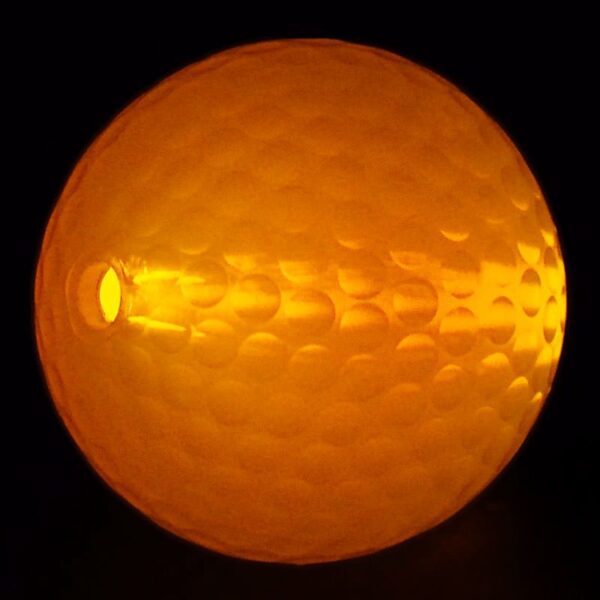 A close up of an orange ball with light shining on it.