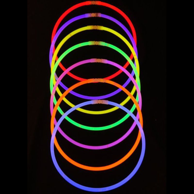 A bunch of different colored glow sticks in the dark