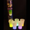 A group of glow shot glasses sitting on top of a table.