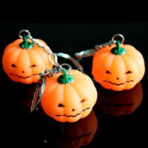 Three pumpkins with faces on them are sitting on a table.