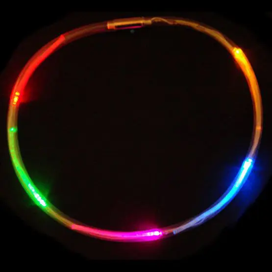 A neon light up hula hoop in the dark.