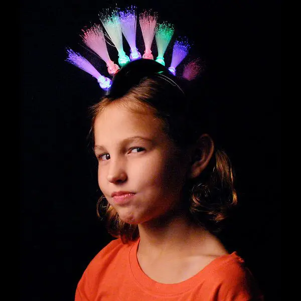 A girl with a light up headband on her head.