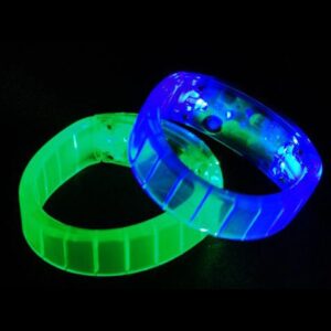 A pair of glowing bracelets sitting on top of a table.