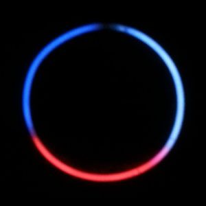 A red and blue light ring on black background.
