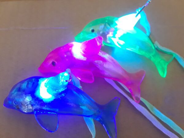 A group of three fish with lights on them.