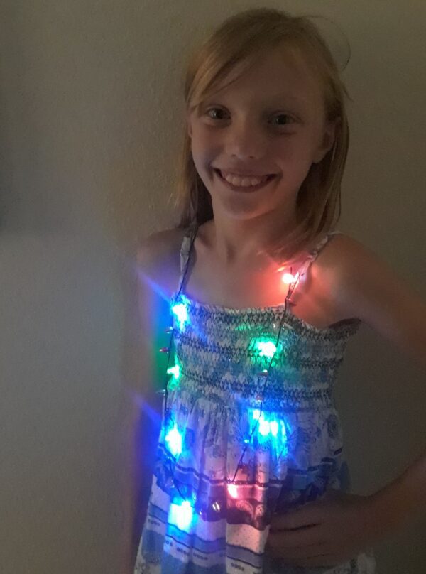 A girl wearing lights in her dress