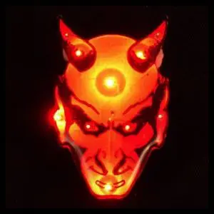 A demonic looking mask with glowing eyes and horns.