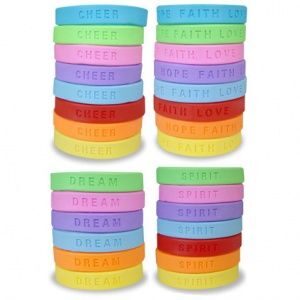 A bunch of different colored bracelets stacked on top of each other