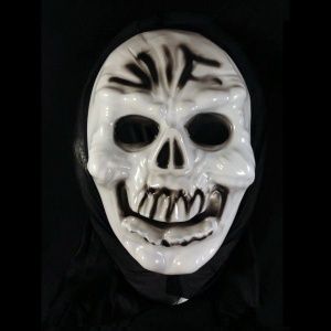 A white skull mask with black markings on it.