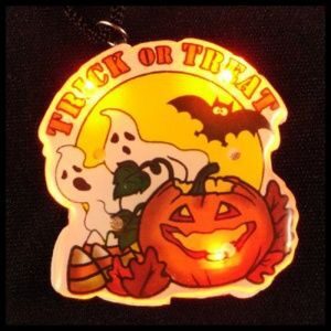 A trick or treat halloween ornament with lights.