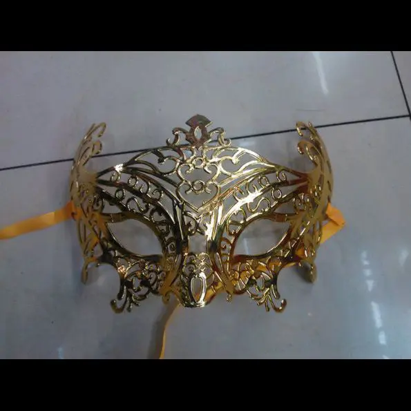 A gold mask is laying on the floor.